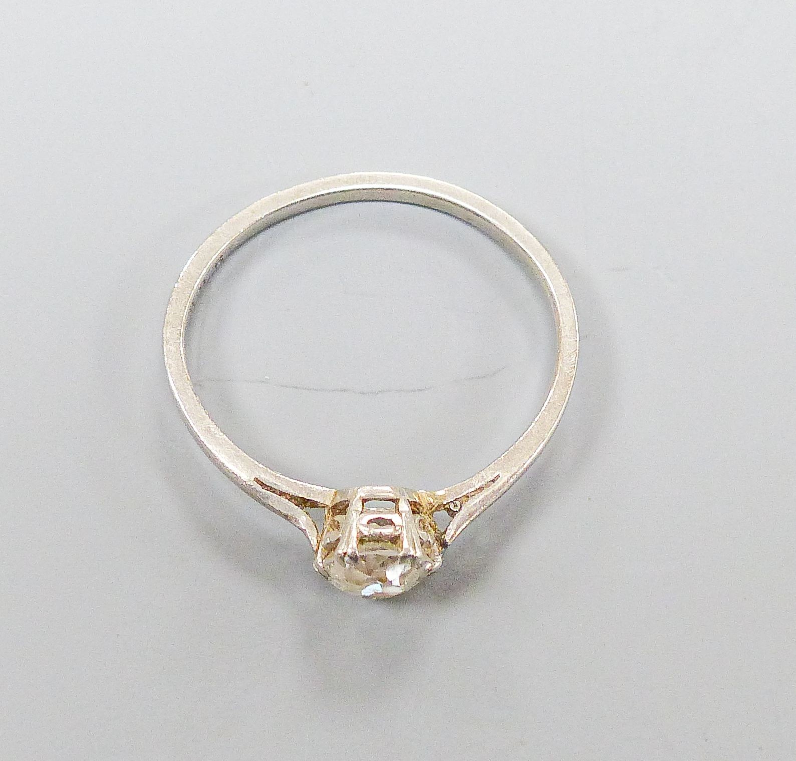 A white metal and solitaire diamond set ring, size K/L, gross weight 2.4 grams